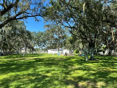 a park with trees and a green field with grass at Home in Kissimmee with Huge Backyard in Kissimmee