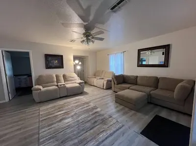 a living room with two couches and a ceiling fan at Home in Kissimmee with Huge Backyard in Kissimmee
