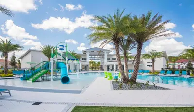 a resort pool with a slide and palm trees at Veranda Palms 8 Bedroom Home with Pool2208 in Kissimmee