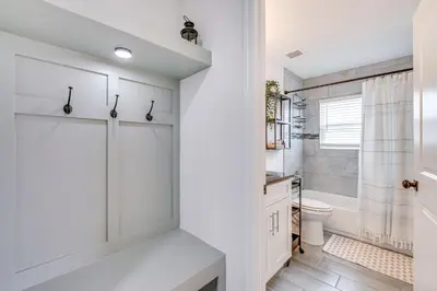 a white bathroom with a toilet and a shower at Modern Florida Bungalow 3 Miles to Winter Garden! in Montverde