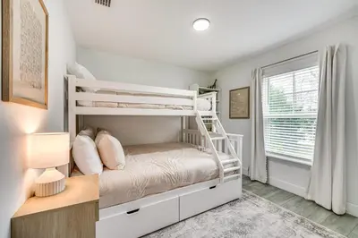 a bedroom with a bunk bed and a window at Modern Florida Bungalow 3 Miles to Winter Garden! in Montverde