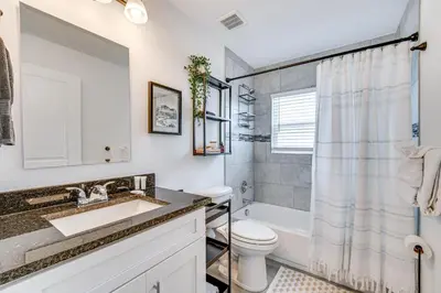 a bathroom with a sink and a toilet at Modern Florida Bungalow 3 Miles to Winter Garden! in Montverde
