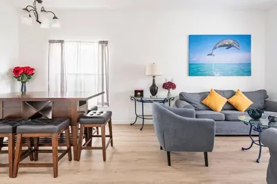 a living room with a table and a couch at Comfortable House with hot tub close to Disney in Kissimmee