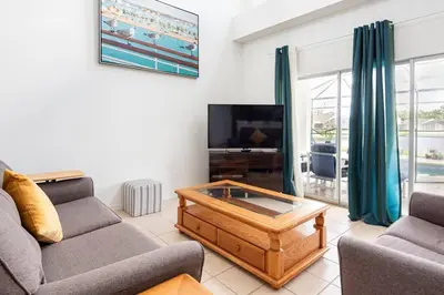 a living room with a couch and a coffee table at Comfortable House with hot tub close to Disney in Kissimmee