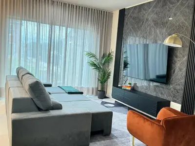 a living room with a couch and a flat screen tv at Wonderful towhouse very close to Disney in Orlando