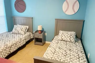 a bedroom with two beds and a baseball on the wall at 4br/3ba Disney Area Luxury Resort with pool/spa in Orlando