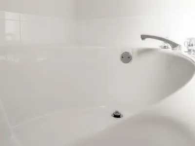 a white bath tub with a sink in a bathroom at 4 Bed 2269 in Kissimmee