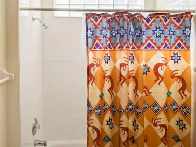 a shower curtain with a dragon pattern on it in a bathroom at 4 Bed 2269 in Kissimmee