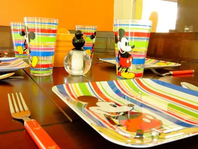 a table with a plate with a mickey mouse on it at 2 Bed 5325 in Kissimmee
