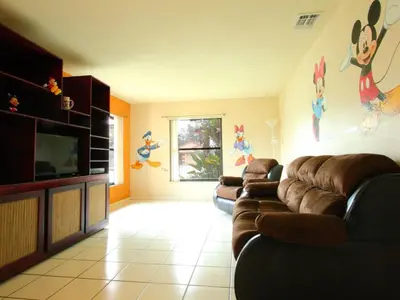 a living room with couches and a flat screen tv at 2 Bed 5325 in Kissimmee