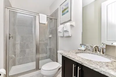a bathroom with a shower and a toilet and a sink at Charming Home With Themed Rooms, Game Room And Waterpark & Resort Access Near Disney At Encore Resorts Reunion - 300Pn in Kissimmee