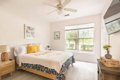 a white bedroom with a bed and a ceiling fan at Newly Renovated First Floor 3Bed & 2 Bath, OUTDOOR POOL, 10-min to Disneyworld & Animal Kingdom! in Kissimmee