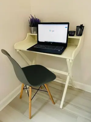 a laptop computer sitting on a desk with a chair at Newly Renovated First Floor 3Bed & 2 Bath, OUTDOOR POOL, 10-min to Disneyworld & Animal Kingdom! in Kissimmee