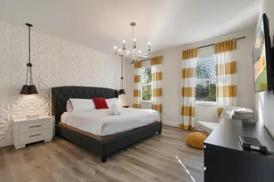 a bedroom with a bed and a desk in it at Elegant Home with Pool & Spa, Close to Disney in Kissimmee