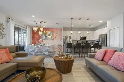 a living room with two couches and a kitchen at Elegant Home with Pool & Spa, Close to Disney in Kissimmee