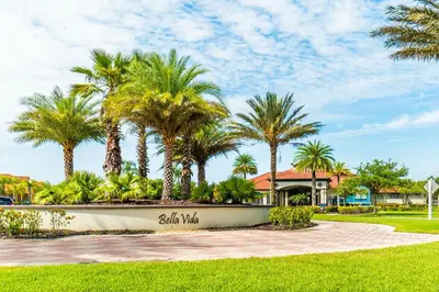 a park with palm trees in front of a house at Elegant Home with Pool & Spa, Close to Disney in Kissimmee