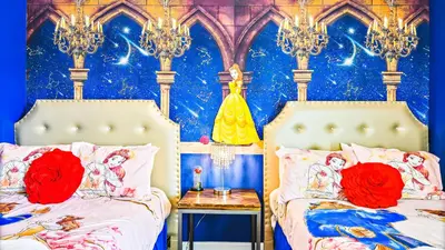 a bedroom with two beds and a wall with a disney mural at Elegant Retreat with Private Spa & Pool in Kissimmee