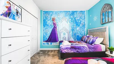 a bedroom with a purple bed and a painting on the wall at Storey Lake Resort 6br Family Villa Pool by Disney in Kissimmee