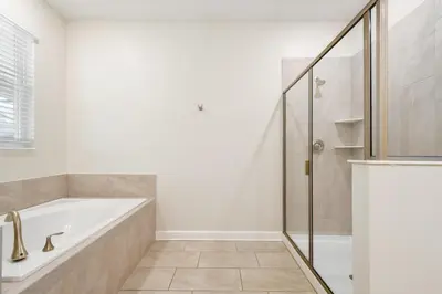 a white bathroom with a tub and a shower at Storey Lake Getaway Pool SPA Theater in Kissimmee