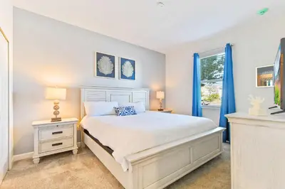 a bedroom with a white bed and a window at Resort Home: Game Room, Pool, Near Disney in Kissimmee