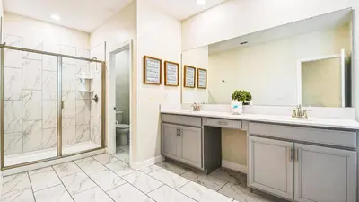 a bathroom with a sink and a shower at Storey Lake Cozy Resort Home Pool Spa Disney Theme in Kissimmee