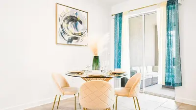 a dining room with a table and chairs at 4BR Tropical Storey Lake Townhome Private Pool in Kissimmee