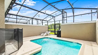 a swimming pool in a building with a glass ceiling at 4BR Tropical Storey Lake Townhome Private Pool in Kissimmee