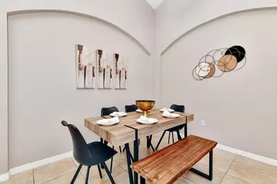 a dining room with a wooden table and chairs at Lakeview Luxury Oasis in Kissimmee