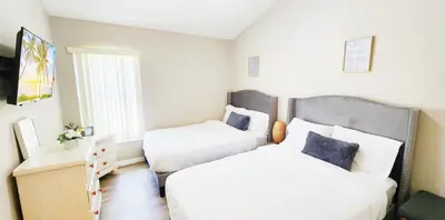 a bedroom with two beds and a desk at Lakeview Luxury Oasis in Kissimmee