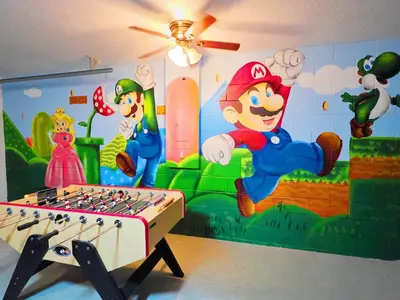 a room with a mural of mario games on the wall at Lakeview Luxury Oasis in Kissimmee