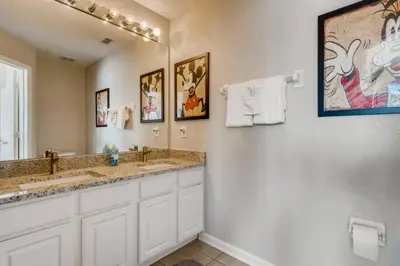 a bathroom with two sinks and a large mirror at T7676F Windsor Hills Resort 3Bed POOL Pet Friendly in Orlando