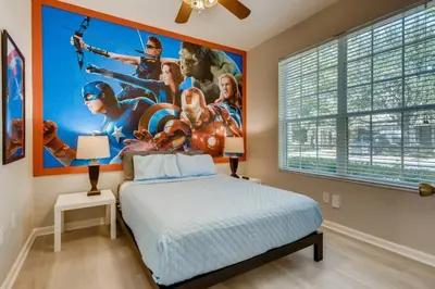 a bedroom with a superhero poster on the wall at T7676F Windsor Hills Resort 3Bed POOL Pet Friendly in Orlando