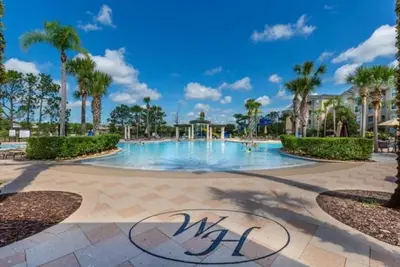 a swimming pool at a resort with palm trees at T7676F Windsor Hills Resort 3Bed POOL Pet Friendly in Orlando