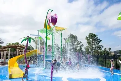 a water park with people playing in a fountain at T7676F Windsor Hills Resort 3Bed POOL Pet Friendly in Orlando