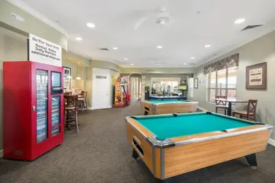 a billiard room with a pool table and a bar at C7671-402 Windsor Hills Resort 2Bedrm Themed Condo in Orlando