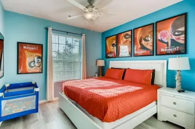 a bedroom with a king sized bed with blue walls at C7671-402 Windsor Hills Resort 2Bedrm Themed Condo in Orlando