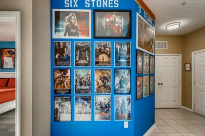 a blue wall with movies on it in a hallway at C7671-402 Windsor Hills Resort 2Bedrm Themed Condo in Orlando