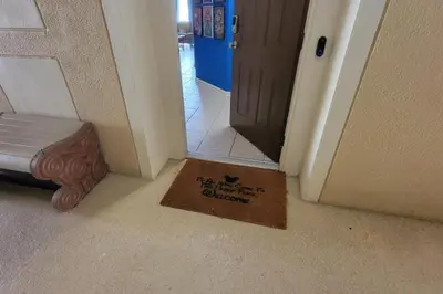 a welcome mat in front of a door in a hallway at C7671-402 Windsor Hills Resort 2Bedrm Themed Condo in Orlando
