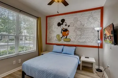 a bedroom with a mickey mouse painting on the wall at T7673F Windsor Hills Resort 3Bed POOL Pet Friendly in Orlando