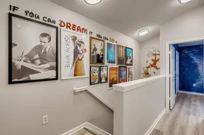 a hallway with a bunch of pictures on the wall at T7673F Windsor Hills Resort 3Bed POOL Pet Friendly in Orlando