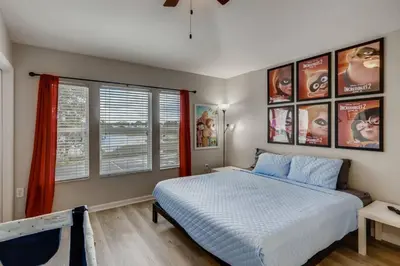a bedroom with a bed and some pictures on the wall at T7673F Windsor Hills Resort 3Bed POOL Pet Friendly in Orlando