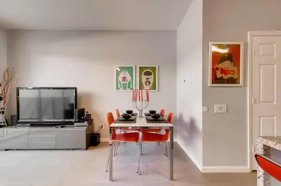 a living room with a table and a television at T2367 Windsor Palm Resort Pool 3 miles to Disney in Kissimmee