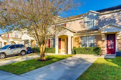 a white car parked in front of a house at T2367 Windsor Palm Resort Pool 3 miles to Disney in Kissimmee