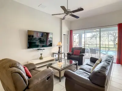 a living room with a couch and a table at H2713M Windsor Hills Resort 4Bedrm POOL SPA Disney in Orlando