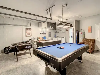 a living room with a pool table in it at H2713M Windsor Hills Resort 4Bedrm POOL SPA Disney in Orlando