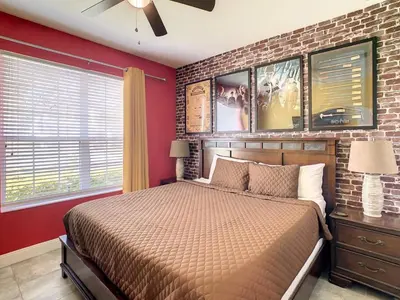 a bedroom with a bed and a brick wall at H2713M Windsor Hills Resort 4Bedrm POOL SPA Disney in Orlando