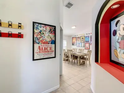a dining room with a movie poster on the wall at H8536 Single Level Pool Spa Home 5 Bed Near Disney in Kissimmee