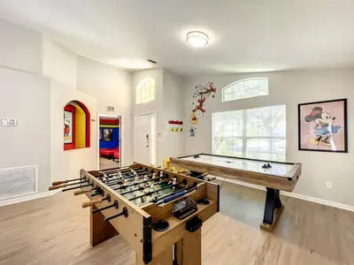 a large room with a large group of game tables at H2631E Resort Single Level POOL SPA Home Disney in Kissimmee