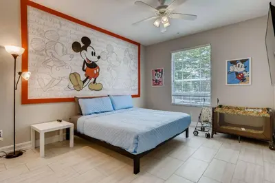 a bedroom with a mickey mouse painting on the wall at C2788-105 Windsor Hills Resort 3Bedrm Themed Condo Water Park in Orlando