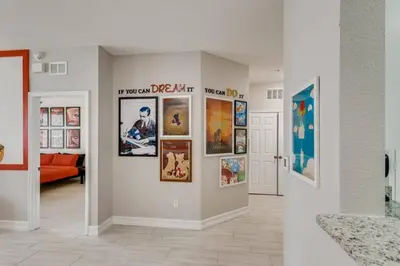 a living room with pictures on the wall at C2788-105 Windsor Hills Resort 3Bedrm Themed Condo Water Park in Orlando